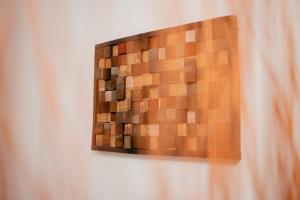 a wooden picture hanging on a wall at Vincellér Apartman in Villány