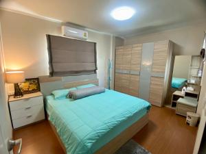 a bedroom with a bed with a blue comforter at J&Y Happy Home in Ban Rong +16 photos