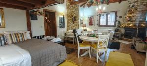 a bedroom with a bed and a table and a living room at Eden Stay in Edessa