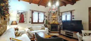 a living room with a television and a fireplace at Eden Stay in Edessa