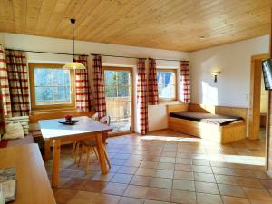 a living room with a bed and a table at Ebner Casa in Heiligenblut