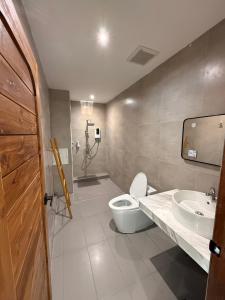 a bathroom with a toilet and a sink at S77 Good View in Roi Et