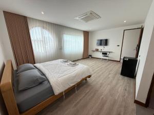 a bedroom with a large bed in a room at S77 Good View in Roi Et