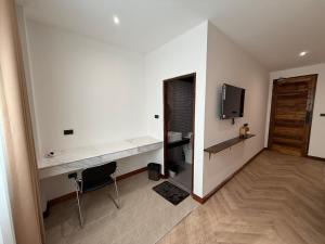 a white room with a desk and a television at S77 Good View in Roi Et +13 photos