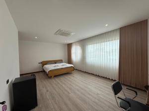 a bedroom with a bed and a tv in it at S77 Good View in Roi Et