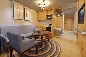 a living room with a couch and a table at Sands Point Hotel in Pondicherry