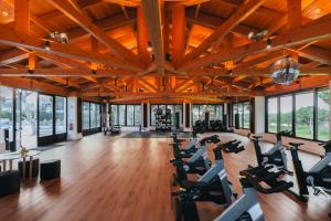 a gym with treadmills and elliptical machines at Pine Cliffs Village in Albufeira