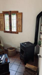 a living room with a stove in the corner at MOZa LUZe - Off Grid Casa Rural in El Pilar y Provincias