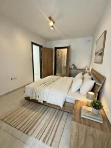 a bedroom with a large bed and a table at Marina District in Pieta