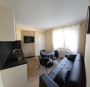 a living room with a couch and a table at Hotel Champ Alsace in Haguenau