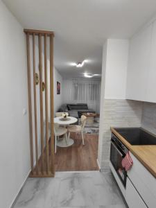 a kitchen and living room with a table and a dining room at High Above 6 in Vranješ