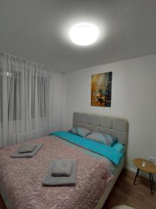 a bedroom with a bed with two towels on it at High Above 6 in Vranješ