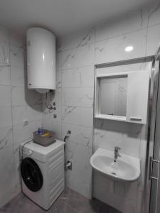 a white bathroom with a sink and a mirror at High Above 6 in Vranješ +14 photos