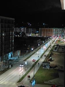 a city street at night with people and lights at High Above 6 in Vranješ