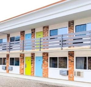 a building with many windows with different colored doors at MXP Special Rooms in Saskatoon