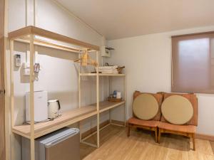 a room with a desk and a chair in it at The Goose House Ubon in Ban Na Khwai