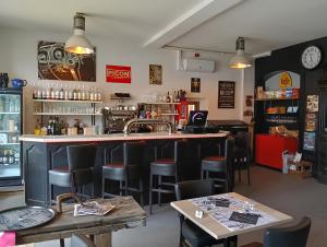 a bar in a restaurant with chairs and tables at hotel de france in Vatan