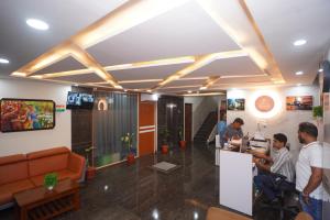 a lobby of a office with people working at a counter at Hotel Stay Bliss Marathahalli in Bangalore