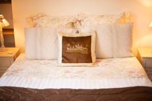 a bed with white sheets and a pillow on it at Villa MONIKA in Dieppe