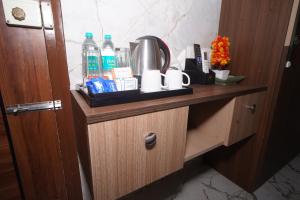 a wooden cabinet with bottles of water on it at Hotel Stay Bliss Marathahalli in Bangalore