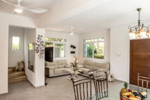 a living room with a couch and a table at Villa Mesogeios 39 in Paralimni