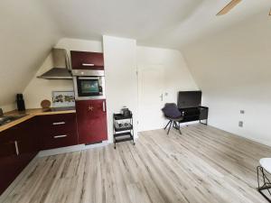 a living room with a kitchen and a desk at Nordlandgiebel in Rosengarten