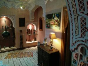 a room with a lamp on a dresser in a room at Riad Fadela in El Jadida