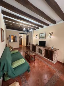 a living room with a couch and a fireplace at Apartamentos Turísticos La Posada in Oropesa