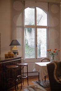 a room with a table and chairs and a window at Villa MONIKA in Dieppe
