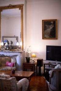 a living room with a fireplace and a television at Villa MONIKA in Dieppe