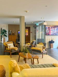 a living room with couches and chairs at Hotel Rothaus Luzern & Peruvian Culinary Art in Lucerne