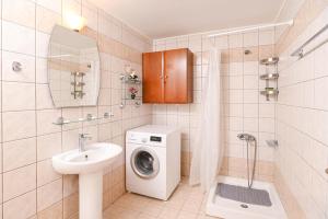 a bathroom with a washing machine and a sink at Efrosini & Ioanna Apartment in Ligaria +54 photos