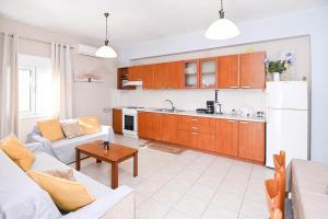a living room with a couch and a kitchen at Efrosini & Ioanna Apartment in Ligaria