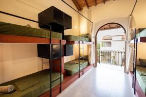 a room with several bunk beds in a house at Lucky U Hostel in Ahangama