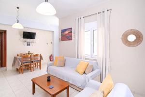 a living room with a couch and a table at Efrosini & Ioanna Apartment in Ligaria