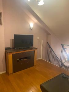 a living room with a flat screen tv on a stand at ホテルラブリー淡路島 in Sumoto +4 photos