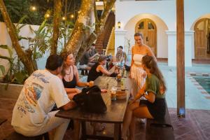 a group of people sitting around a table at Lucky U Hostel in Ahangama