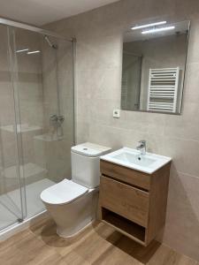 a bathroom with a toilet and a sink and a shower at El Far de Palamós - Costa Brava in Palamós +5 photos