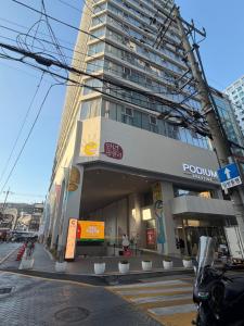 a building on a city street with a building at 해변1분 숙소 광안이즘, 1 min to beach Gwangan-ism in Kwangan-dong