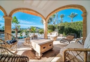an outdoor patio with chairs and a table at La Finca Blanca Javea in El Tosalet