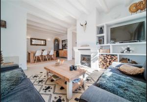 a living room with a couch and a table at La Finca Blanca Javea in El Tosalet