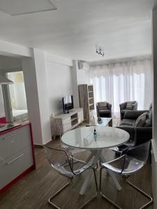 a living room with a white table and chairs at La Terraza de María P in Torre del Mar +9 photos