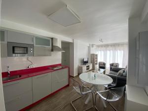 a kitchen with a table and a living room at La Terraza de María P in Torre del Mar
