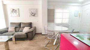 a living room with a couch and a table at La Terraza de María P in Torre del Mar