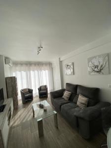 a living room with a couch and a coffee table at La Terraza de María P in Torre del Mar