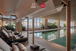 a hotel lobby with a swimming pool and a building at Park Hyatt Changsha in Changsha