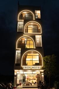a tower building with a try hotel lit up at night at TROY HOTEL - Bà Rịa in Ấp Long Kiên I