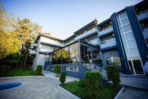 a large blue building with a lot of windows at Хотел и Вили Марая apartament in Tsarevo +8 photos