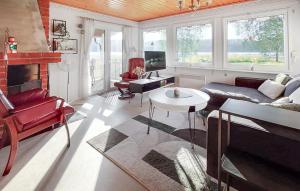 a living room with red furniture and a fireplace at 2 Bedroom Nice Home In Kramfors in Kramfors