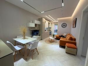 a living room with a table and a couch at Onis Apartment in Vlorë